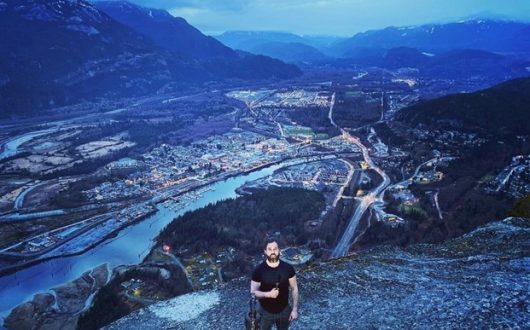 Mike standing on top of the Stawamus Chief Mountain with Howe Sound in the background